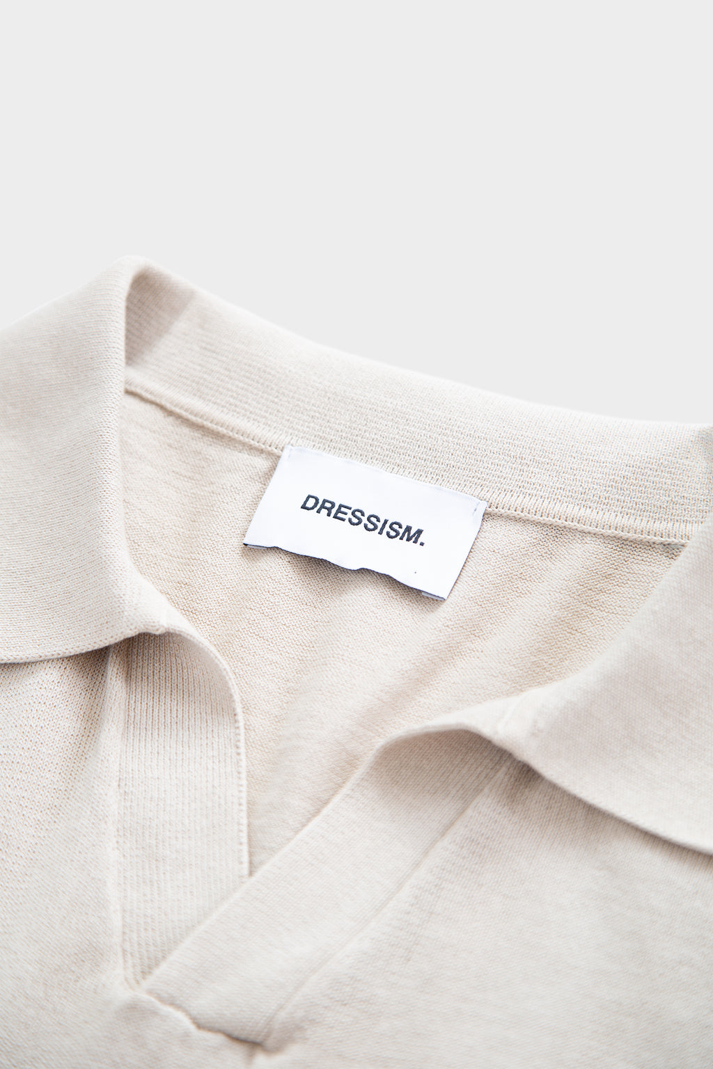 Sand-colored cotton polo shirt with open collar